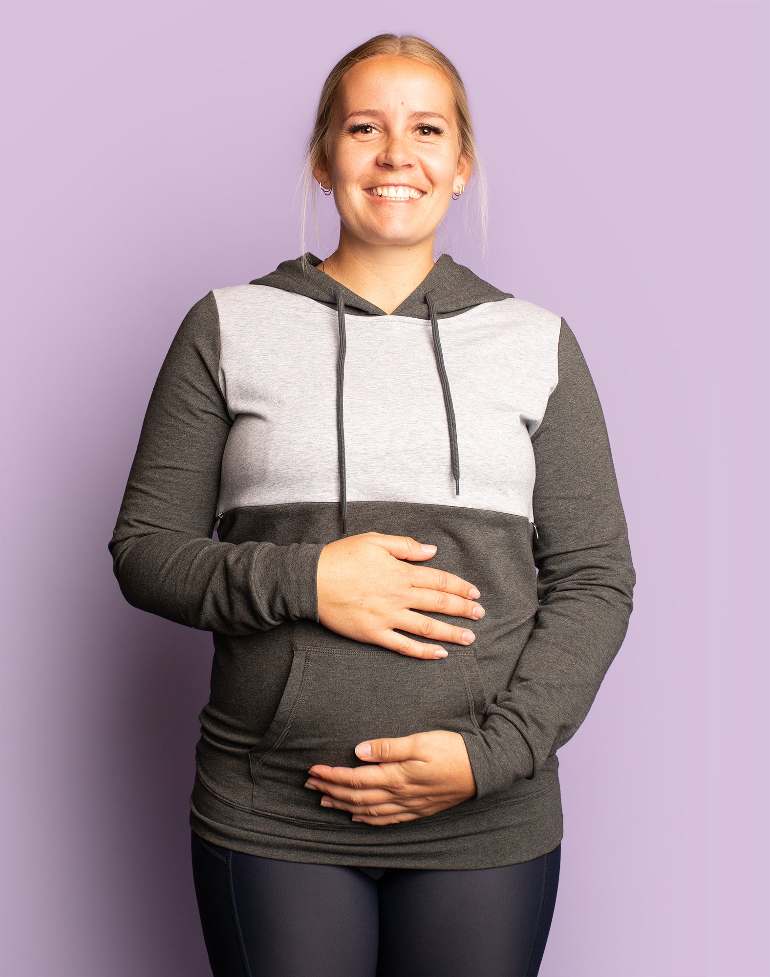 pregnant mother stays warm in a breastfeeding hooded sweatshirt