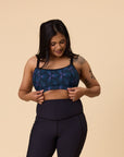 Side view of happy mother wearing high support sports bra