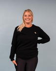 Happy active mother wearing nursing-friendly crew neck jumper