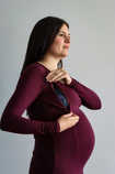 Side on view of pregnant women wearing a bamboo long sleeve top