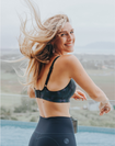 Side view of happy mother wearing high support sports bra