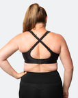 Back view of breastfeeding mum using the fastening clip on the back of a plus size nursing bra