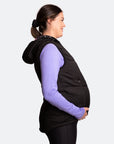 Pregnant mother wearing a black womens puffer vest