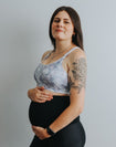 pregnant woman wearing a pastel print crossover nursing sports bra