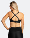 Back view of active mum wearing black nursing sports bra with crossover straps