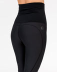 back view of a pregnant woman wearing black full length maternity leggings