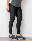 active mum wearing black full length maternity leggings to yoga